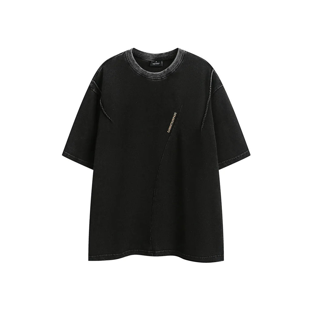 Man wearing a loose black retro short-sleeved cotton T-shirt with an embroidered washed design