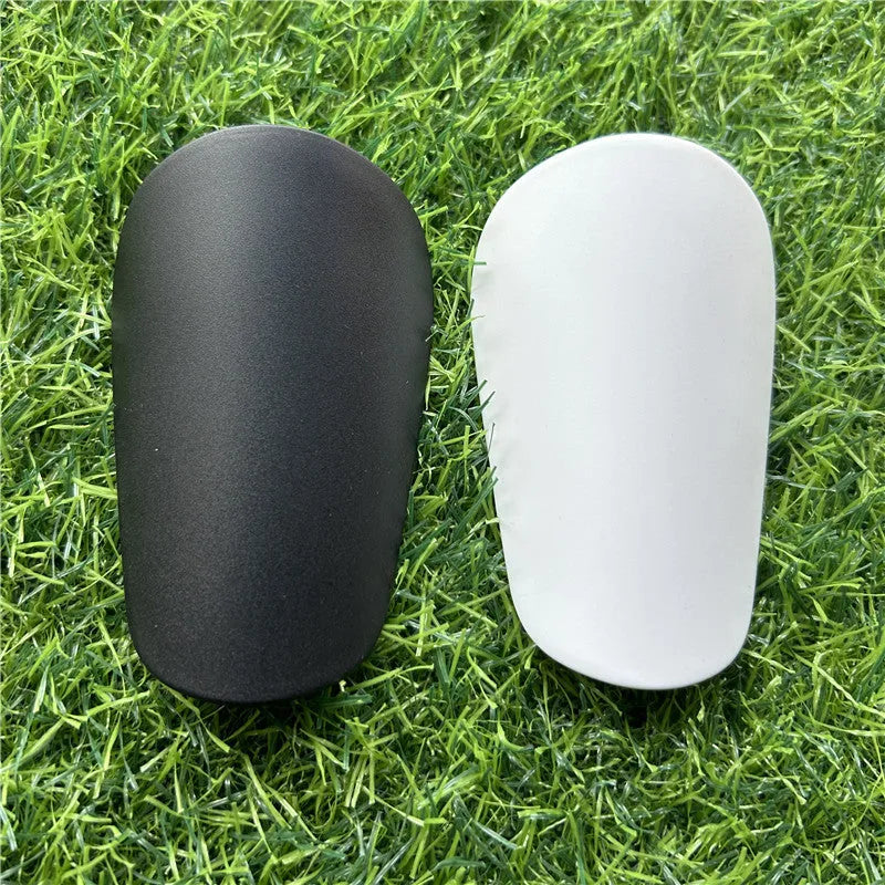 Extra small mini plastic football shin guards in black and white 8x5cm sizes