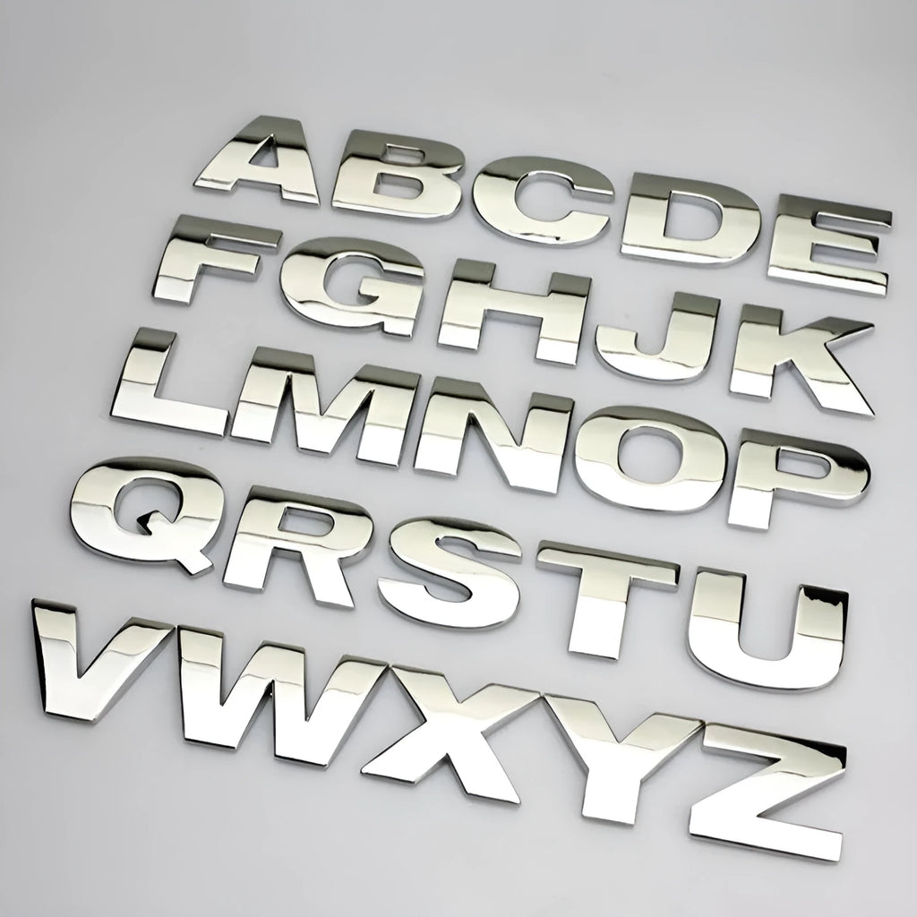 3D metal zinc alloy car letter sticker showing raised silver letter on clear adhesive backing.