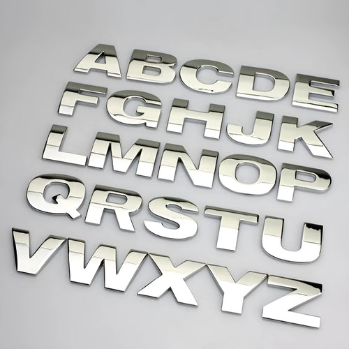 3D metal zinc alloy car letter sticker showing raised silver letter on clear adhesive backing.