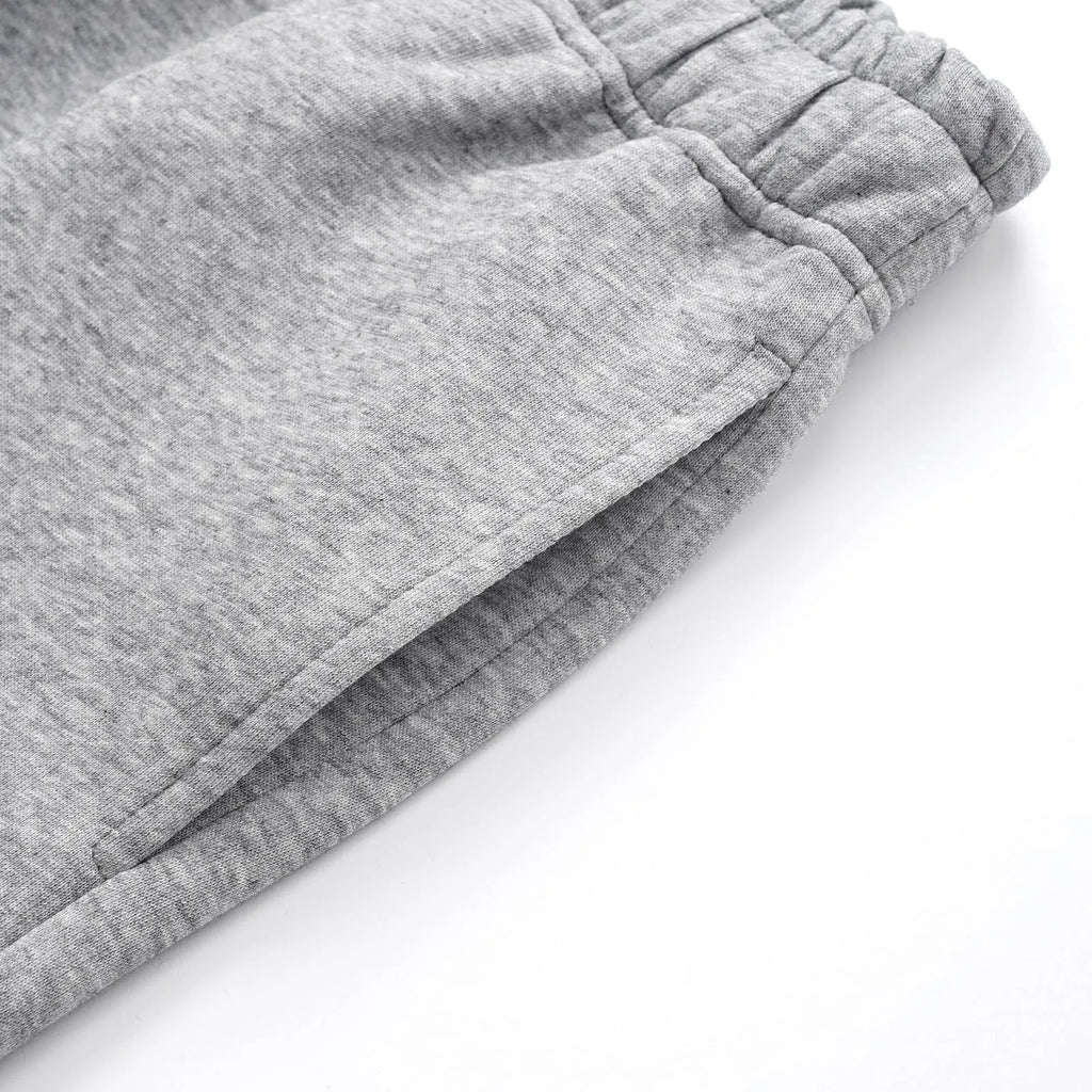 Men's grey straight-leg casual trousers showing wide-leg loose fit and mid waist design