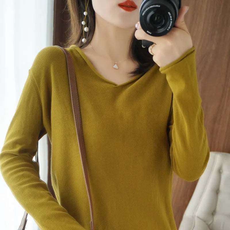 Women's V-neck long sleeve knitwear pullover top in a macaron colour on a hanger.
