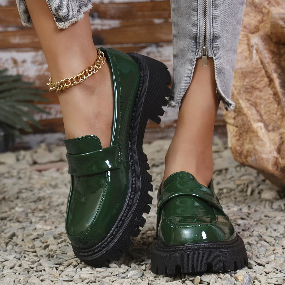 Plus size women's slip-on loafers in black with a chunky platform heel and rubber sole.