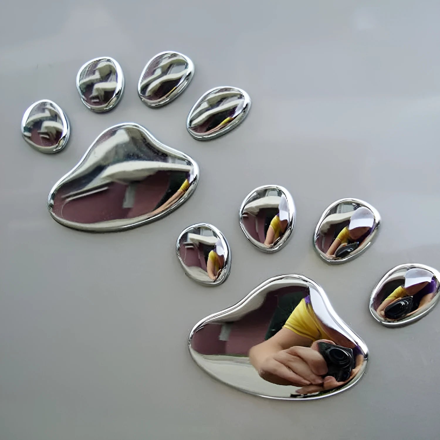 Pair of red dog footprint car stickers in a hand-shaped brush style on a white background.