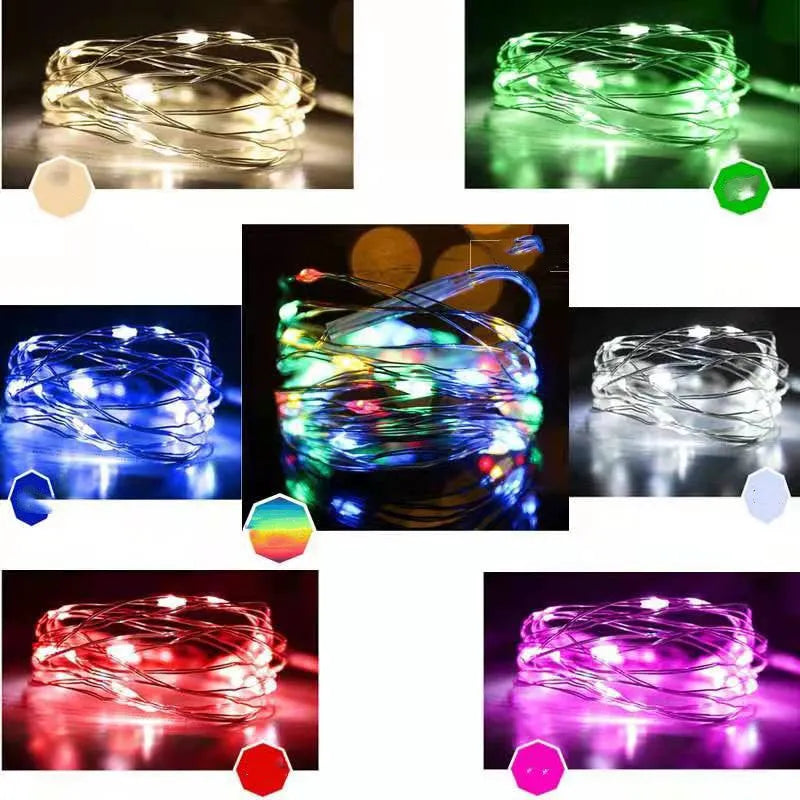 Copper wire battery-operated string lights wrapped around branch with multiple LED colours illuminated