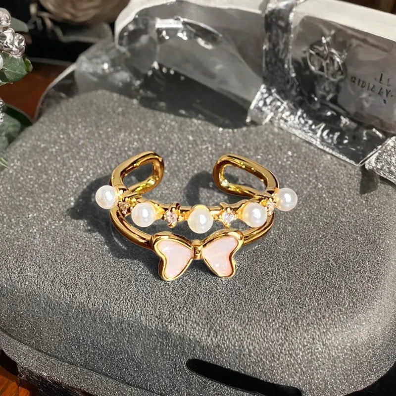 Adjustable copper vintage gourd ring with inlaid zircon stones showing floral and bow design elements