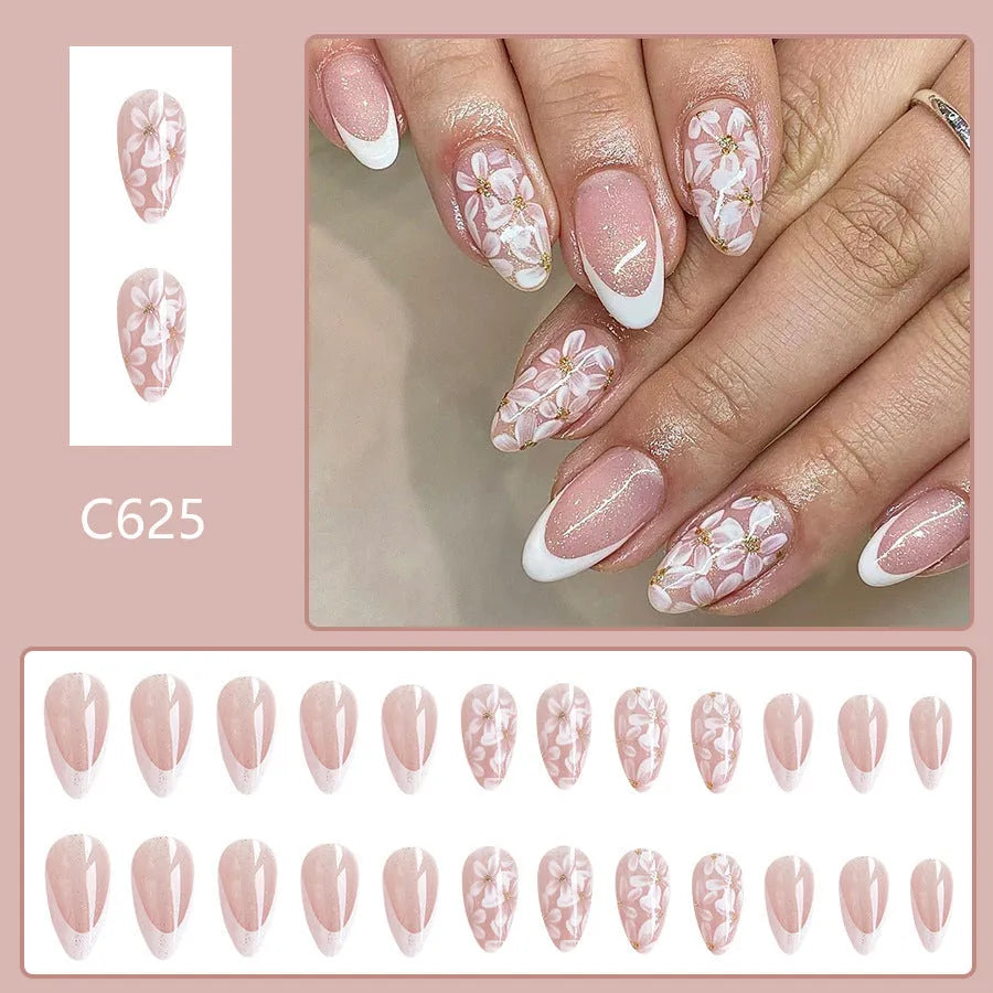 Short almond French manicure press-on nails with glitter flower designs in colour C625