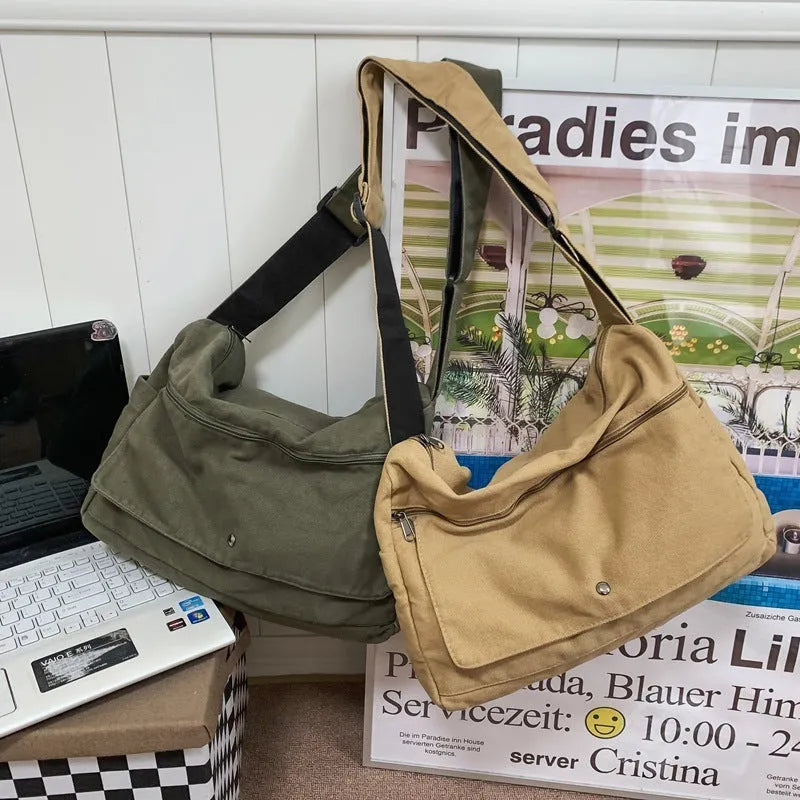 Washed canvas crossbody bag for women in black with single shoulder strap and clamshell shape