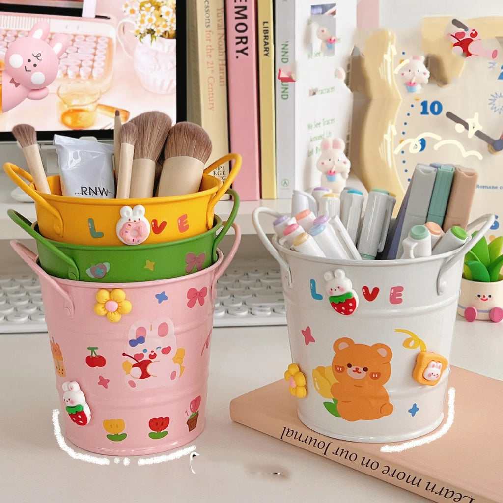 Round metal desktop pen holder in a choice of colours, some with decorative sticker patches.