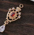 Water drop shaped pendant with crown design and micro inlaid zircon detail in electroplated copper.