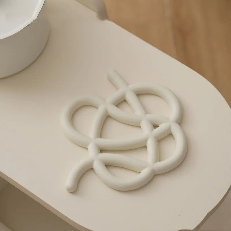 Ceramic heat proof mat with irregular shape and bend and hook design