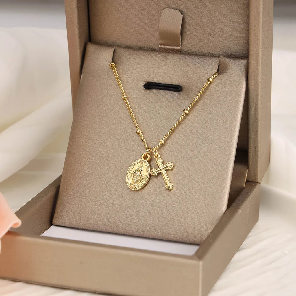 Gold Virgin Mary necklace with geometric cross pendant on copper chain