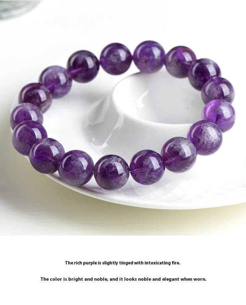 Natural Snow Mountain Purple Feather Amethyst crystal bracelet with scattered geometric beads featuring a Ruyi pattern.
