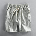 Men's striped cotton casual loose shorts on a hanger showing mid waist and shorts length.
