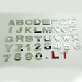 3D metal zinc alloy car letter sticker showing raised silver letter on clear adhesive backing.