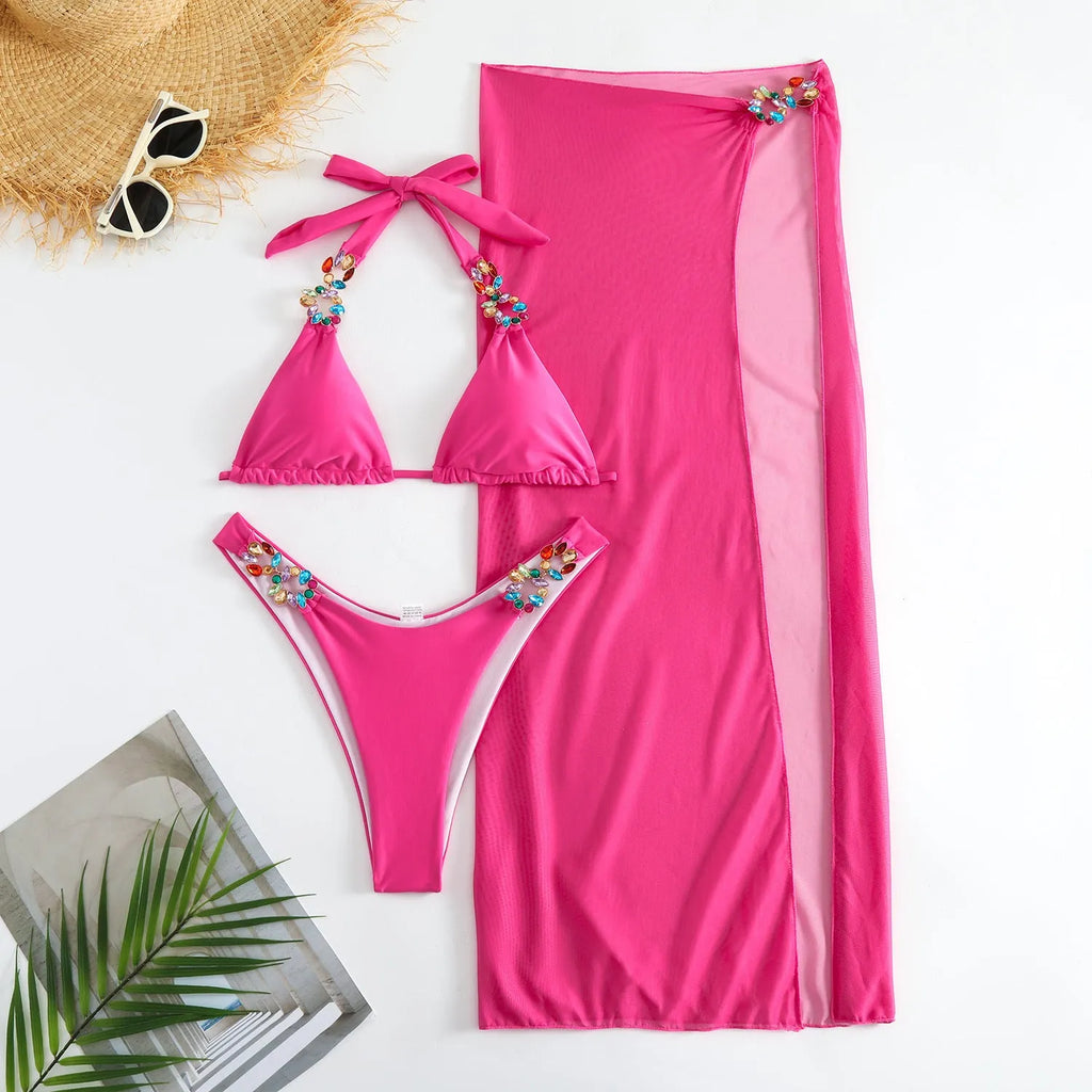 Rose red three-piece swimsuit set with diamond pattern and mesh cover-up skirt.