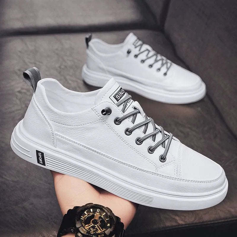 Men's casual white shoes with round toe and flat low-heel sole on a plain background.