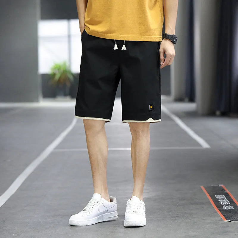 Men's loose-fit casual shorts in khaki colour with elastic waistband, shown on a neutral background.