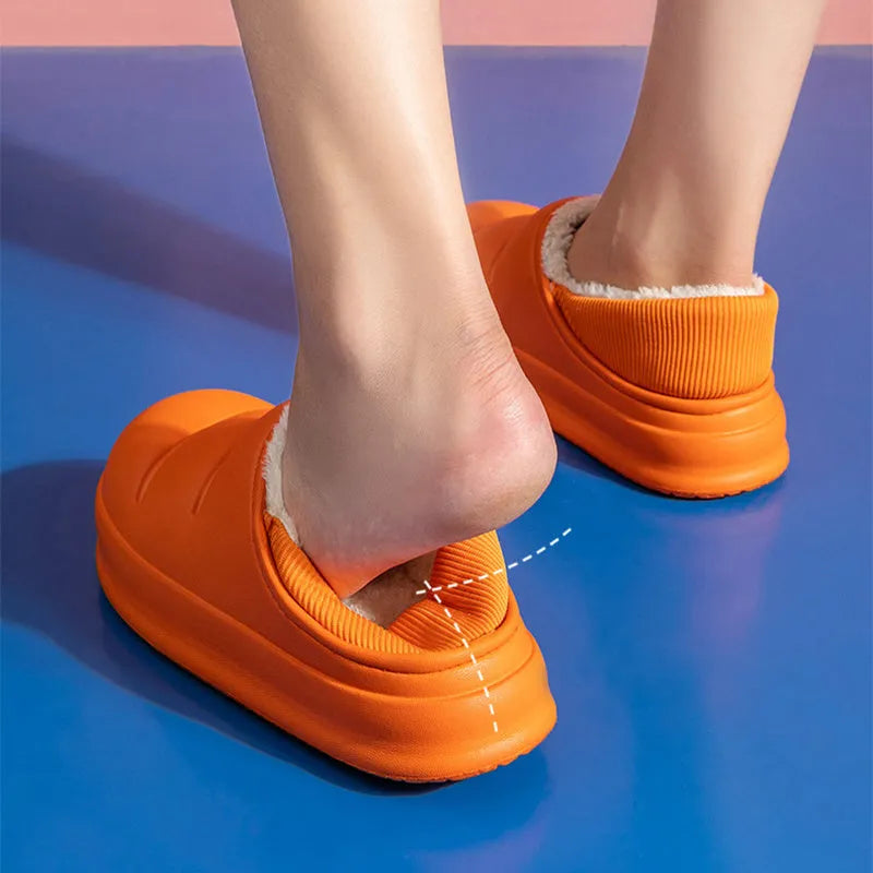 Green EVA waterproof garden slippers with non-slip sole and plush lining shown on wooden decking