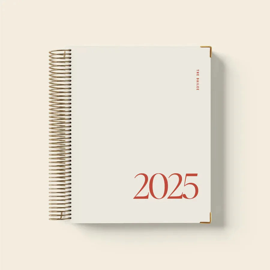 Cherry red coil notebook with daily schedule layout and spiral binding
