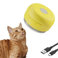 Rechargeable green and yellow silicone steam brush for cat and dog grooming.