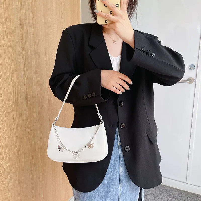 PU leather retro chain underarm bag in horizontal square shape showing crossbody strap and organised interior.