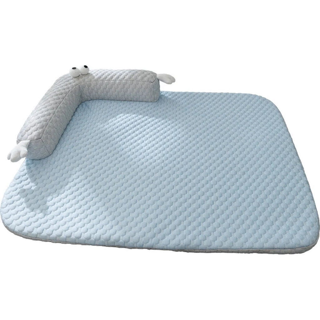 Blue pet cooling mat with big-eyed monster design on a wooden floor, shown in large (L) size.
