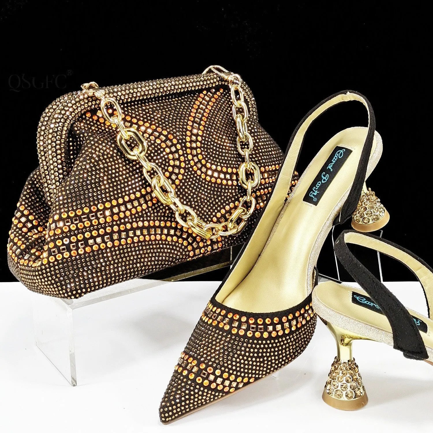 Women's pink pointed toe high heel shoes with rhinestones and a matching small clutch bag.