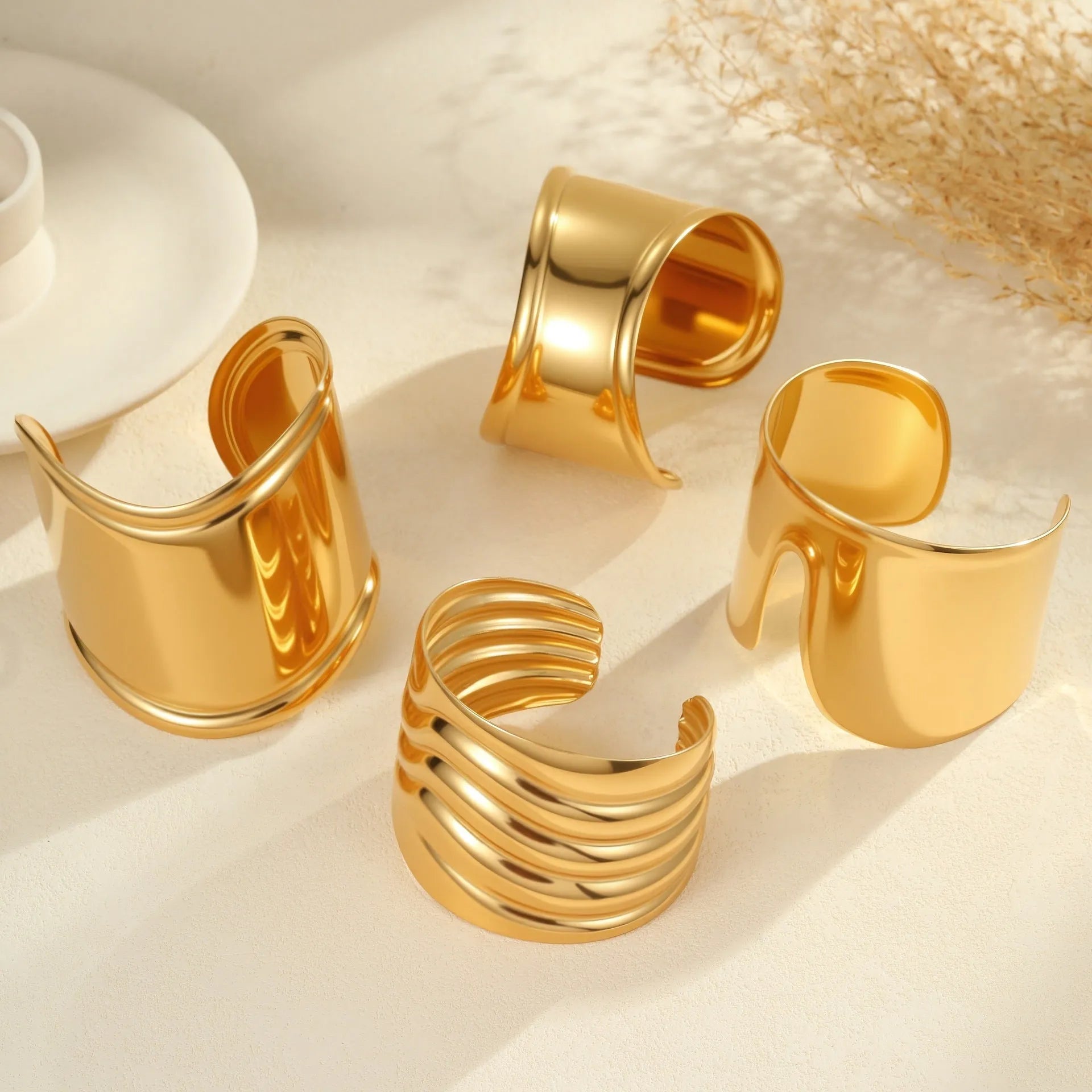 Women's wide cuff bracelet with gold plating and exaggerated niche opening in asymmetric wave design