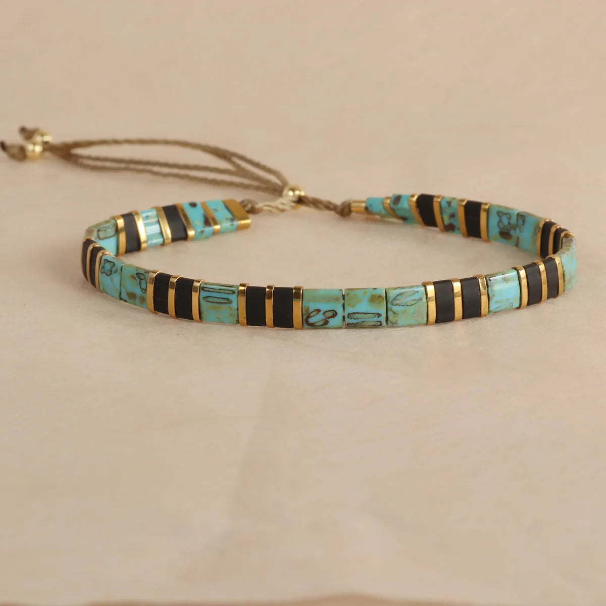 Glass and coloured glaze beaded bracelet with geometric round beads in five colour options