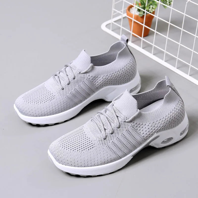 Women's black mesh casual sneakers with round toe, lace-up front, and a soft PVC sole.