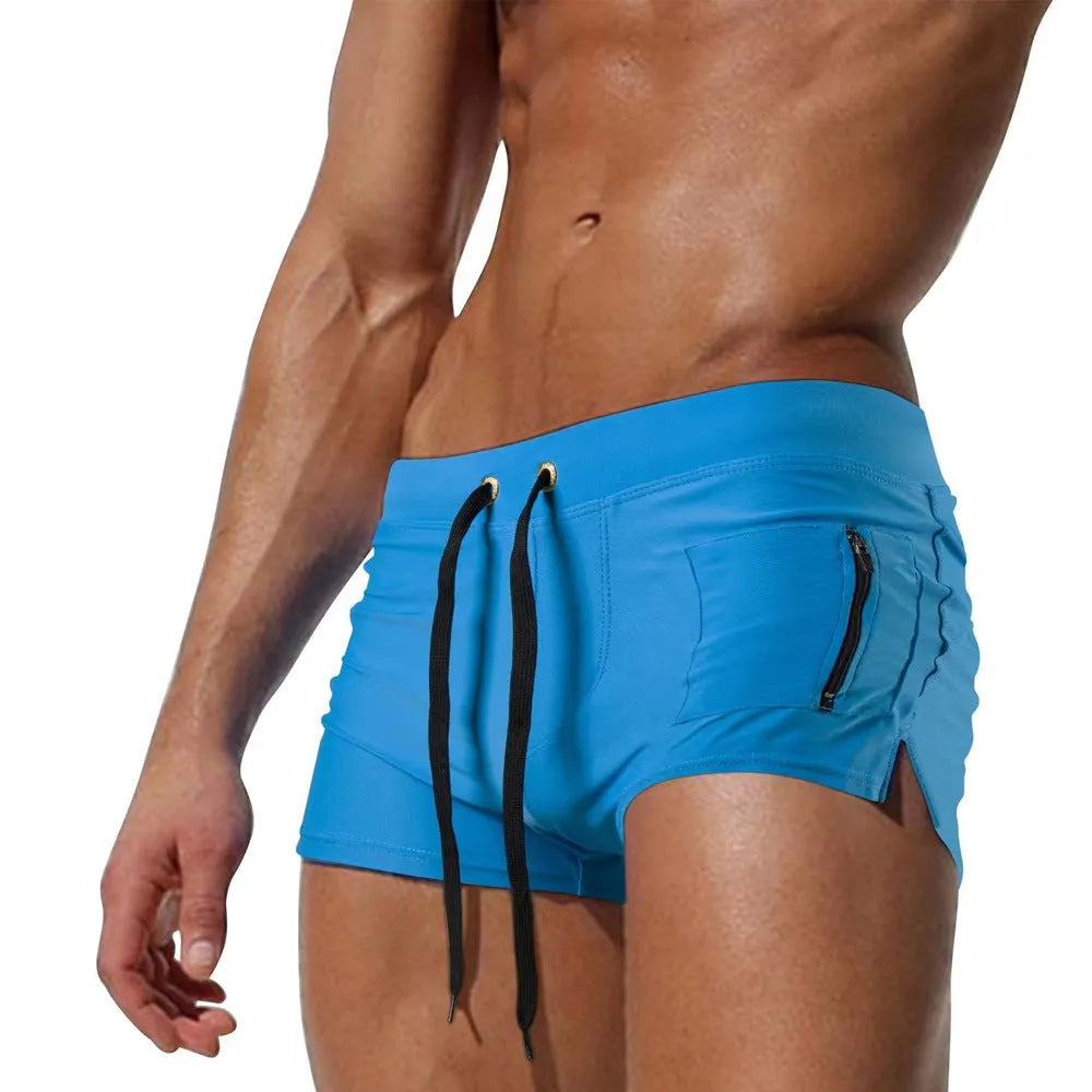 Men's solid colour high-waist swimming trunks with lace-up front, shown in black, for swimming and fitness