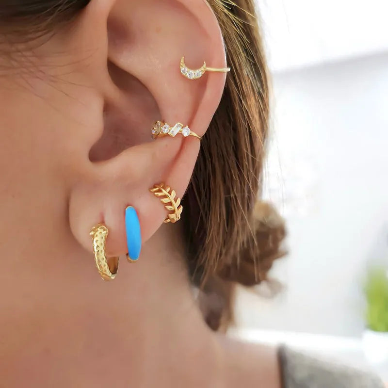 Geometric U-shaped epoxy earrings with a dripping oil finish in various colours.