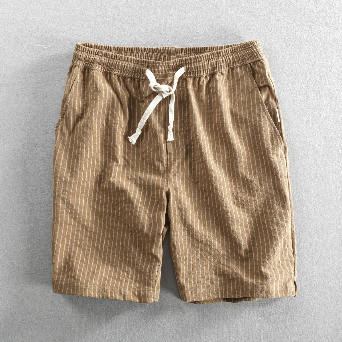 Men's striped cotton casual loose shorts on a hanger showing mid waist and shorts length.