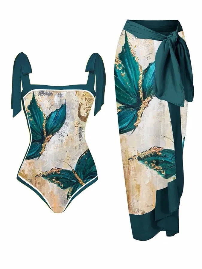 Women's floral print two-piece swimsuit with a blue chiffon skirt laid flat.