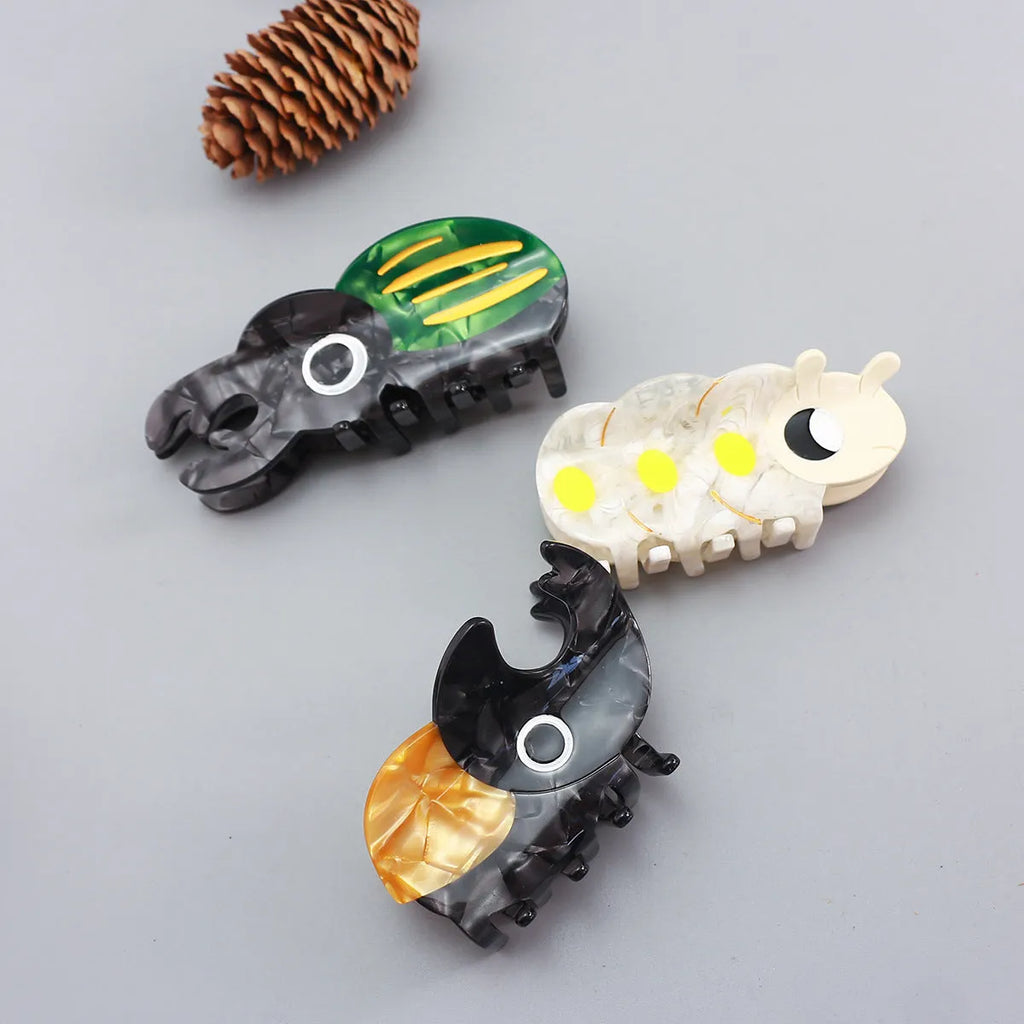 Cellulose acetate sheet Beetle Grip decorative art showing cartoon insect designs in green, orange or white.