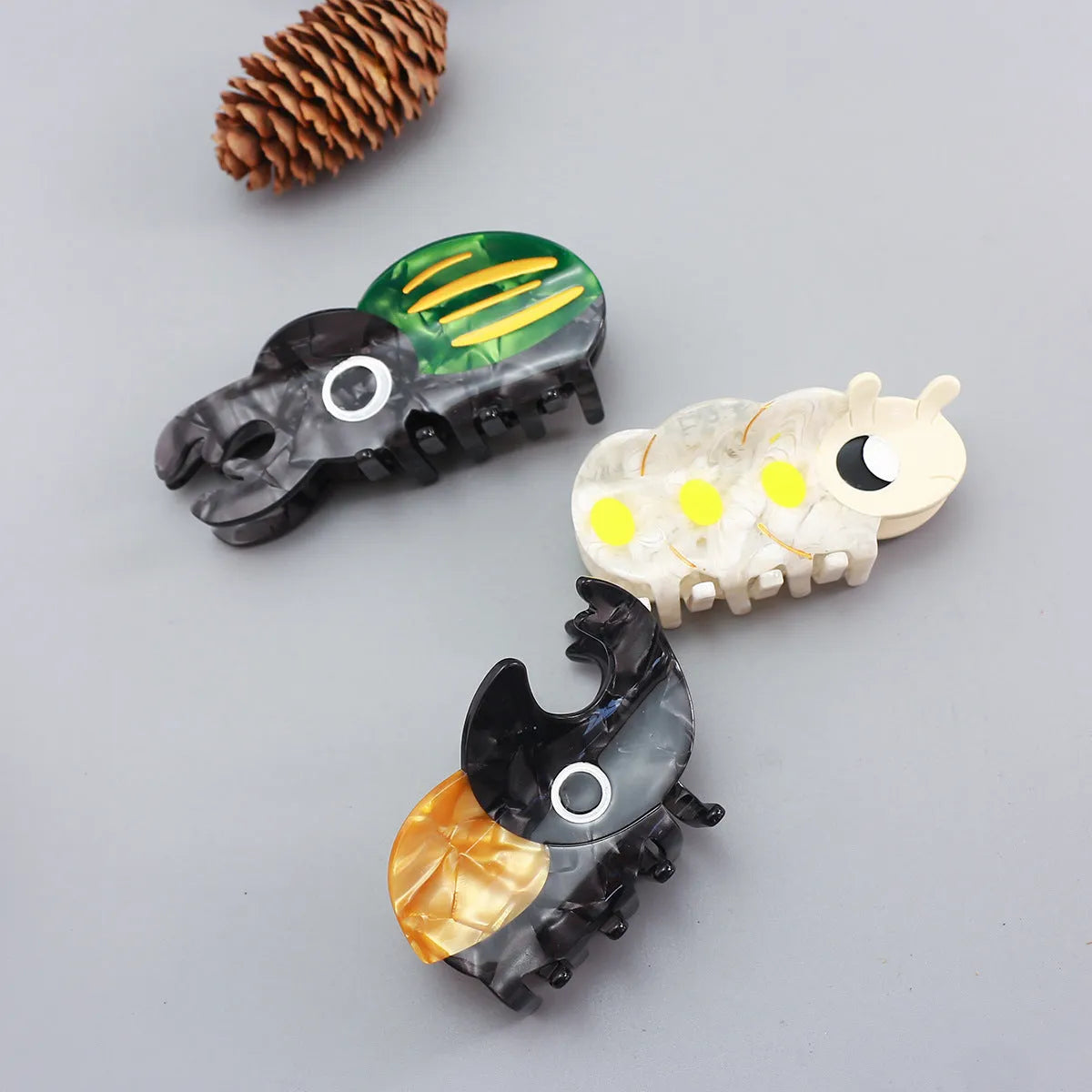 Cellulose acetate sheet Beetle Grip decorative art showing cartoon insect designs in green, orange or white.