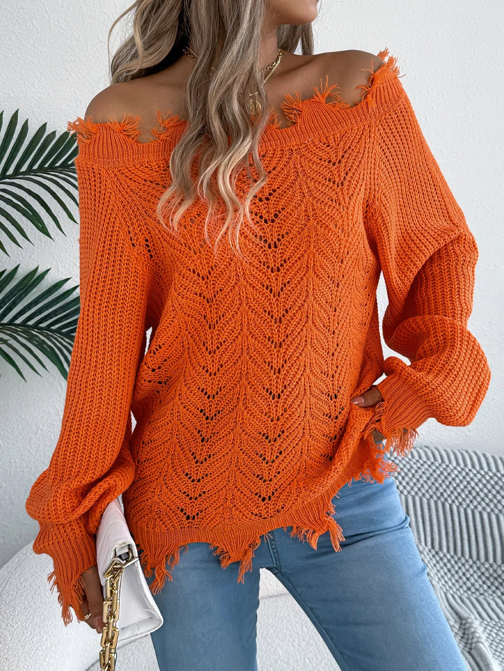 White hollow-out off-the-shoulder pullover sweater with long sleeves on model