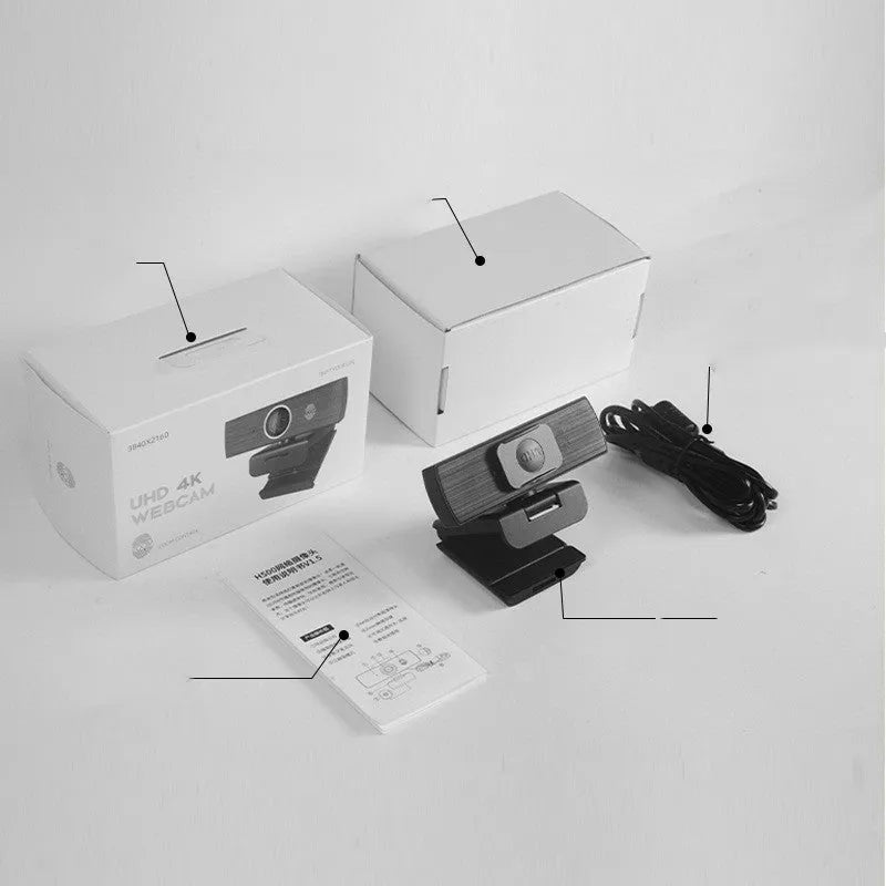 Black 8MP USB webcam with a magnetic privacy cover attached, shown next to its cable and manual.