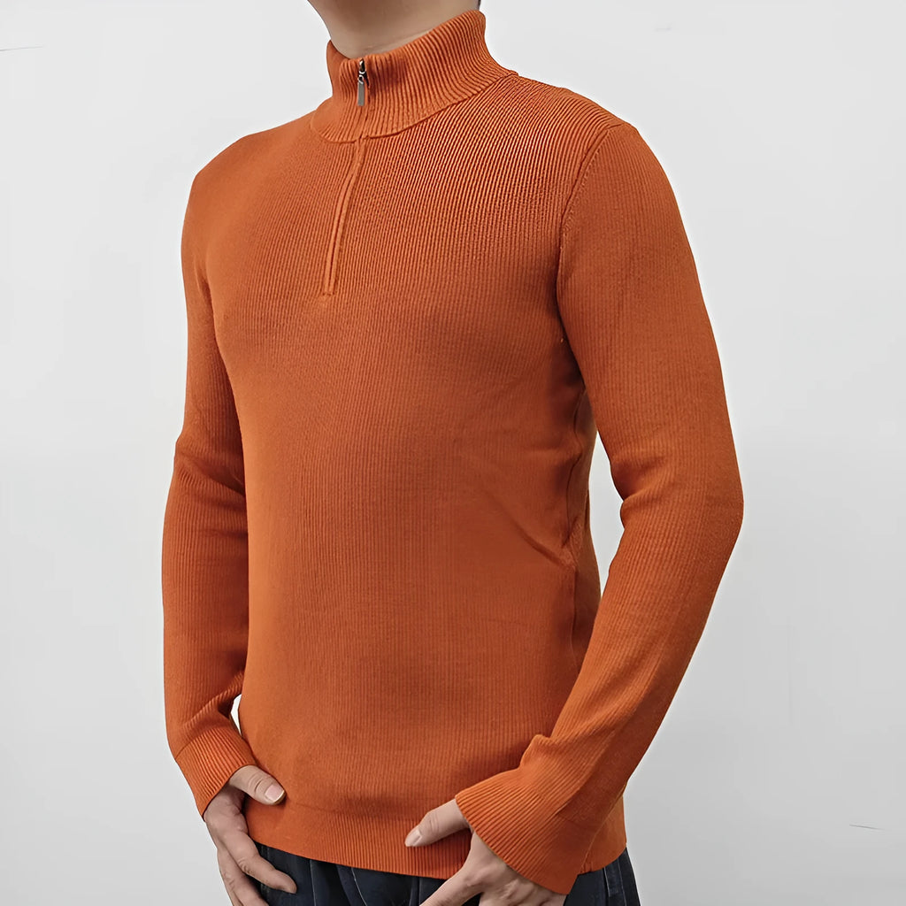 Man wearing a gray zip-front half-turtleneck long sleeve cotton blend sweater.