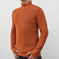 Man wearing a gray zip-front half-turtleneck long sleeve cotton blend sweater.
