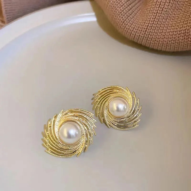 Gold plated pearl earrings with irregular flower shape design on alloy stud backs