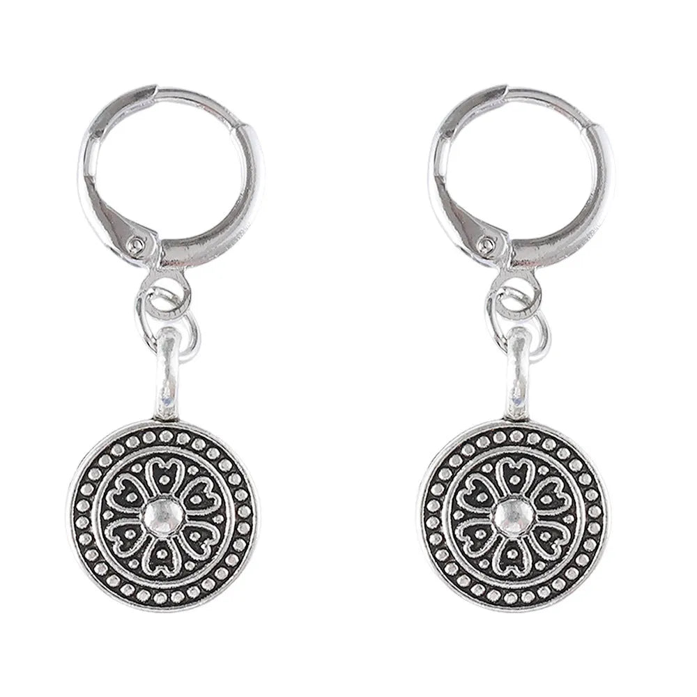 A pair of bohemian retro geometric earrings with a distressed finish and round elements.