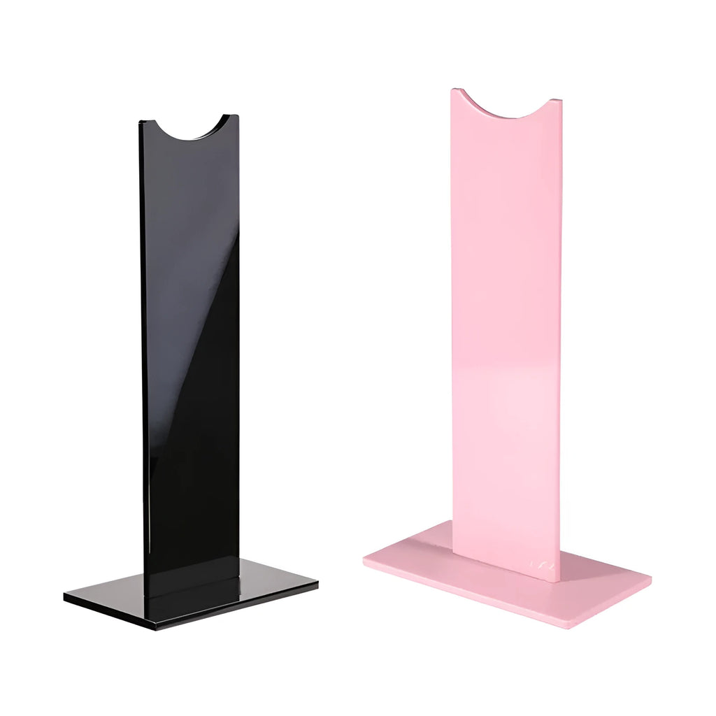 Pink detachable headphone stand for gaming headsets on a desk, shown next to its disassembled parts.