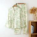Women's pink cotton gauze long sleeve top and trousers matching loungewear set laid flat.