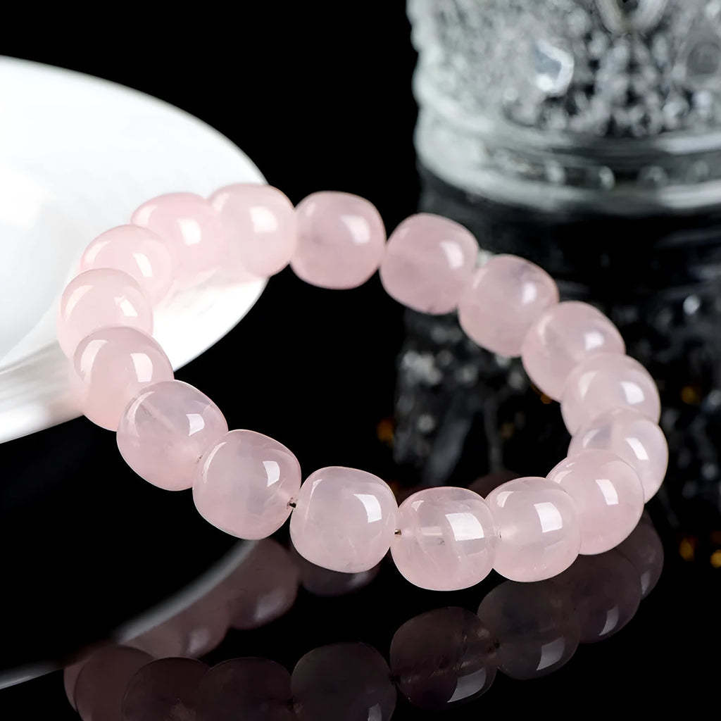 Pink bamboo crystal barrel bead bracelet with geometric 11mm-12mm beads on a wrist.