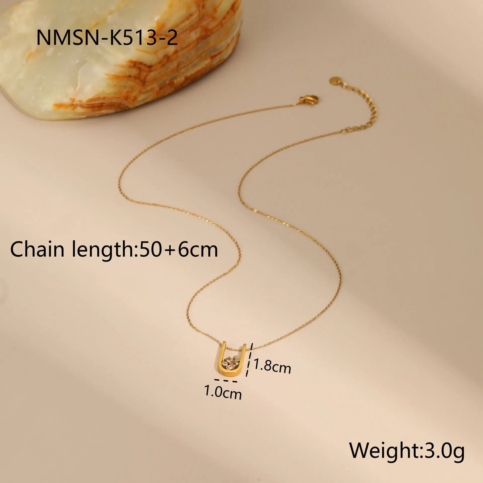 Geometric colour zircon gold plated jewellery set showing necklace, earrings and ring on black background