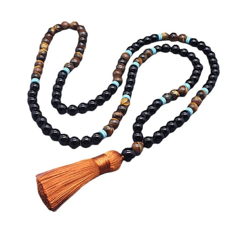 Black geometric agate bracelet and necklace set on a display background.