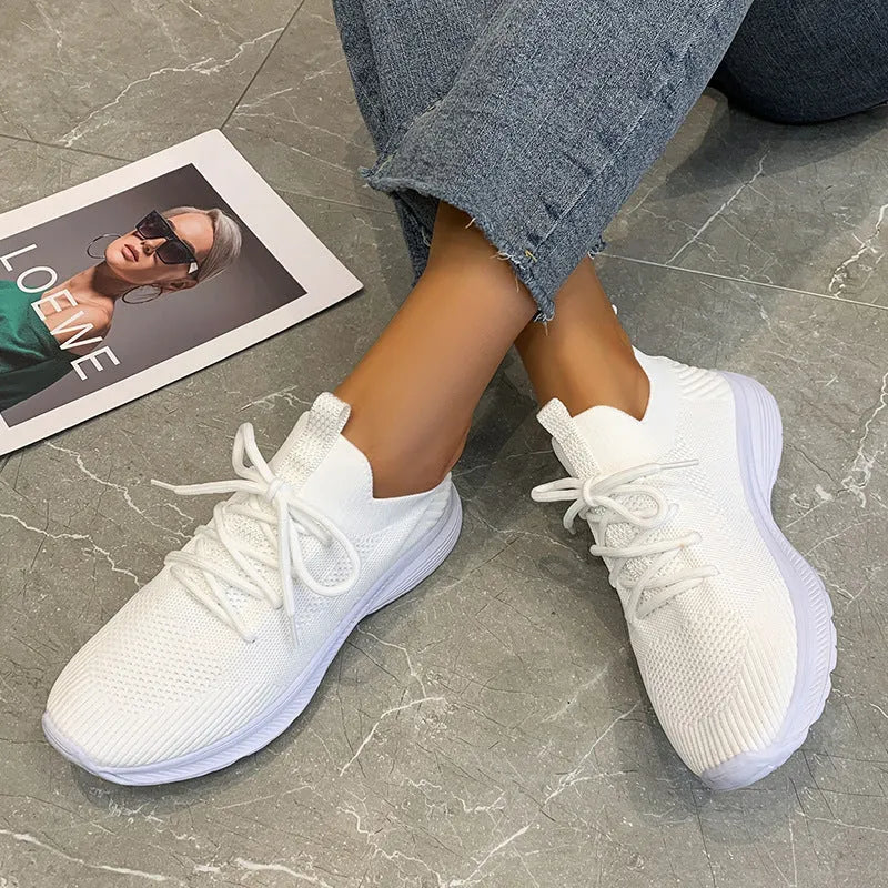 Women's mesh running shoes in Creamy White colour with Flyknit upper and rubber sole