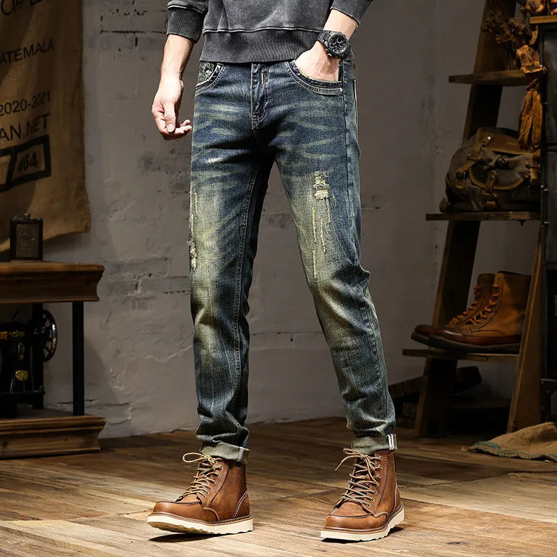 Men's skinny fit retro blue jeans with a zip fly on a grey background